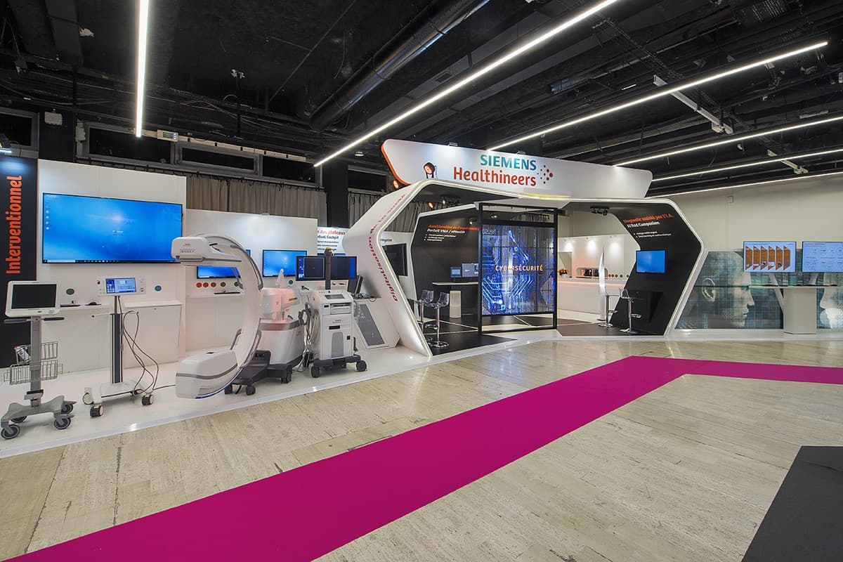 Stand Siemens Healthineers aux Journées Francophones de Radiologie, équipements d'imagerie médicale exposés dans une architecture blanche, conçu et réalisé par The Good Experience